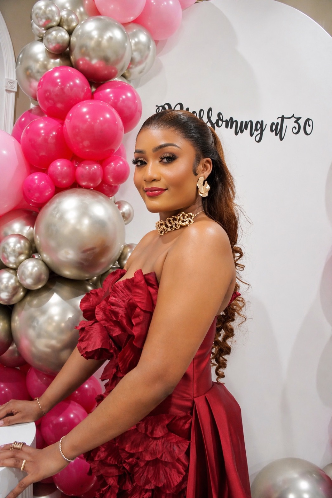 Birthday celebration with pink balloon arch
